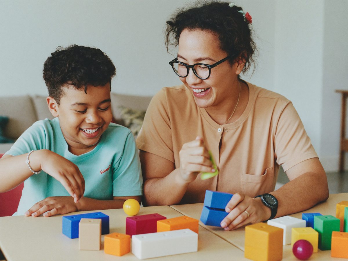 A caregiver and a young person doing a calm sensory-friendly activity together.